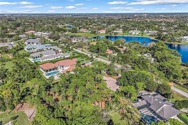 an aerial view of a houses with a lake view