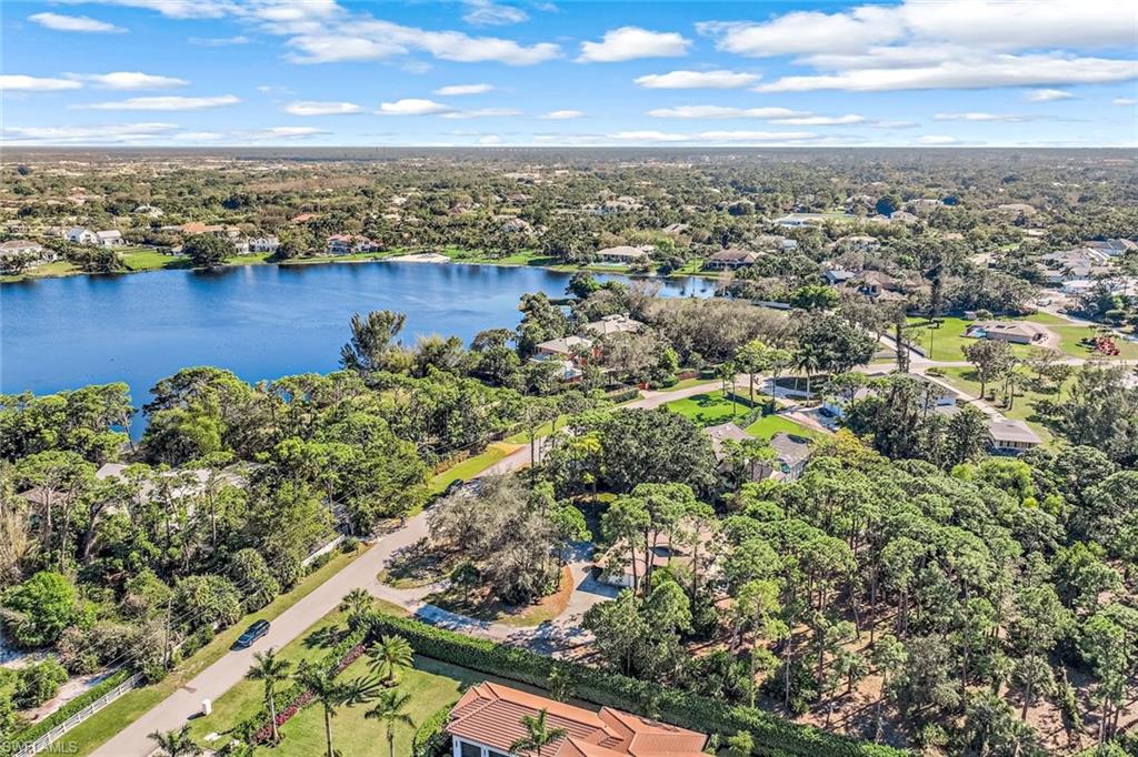 131 Cajeput Drive Naples, FL 34108 - Photo 27 of 30 an aerial view of a houses with a lake view
