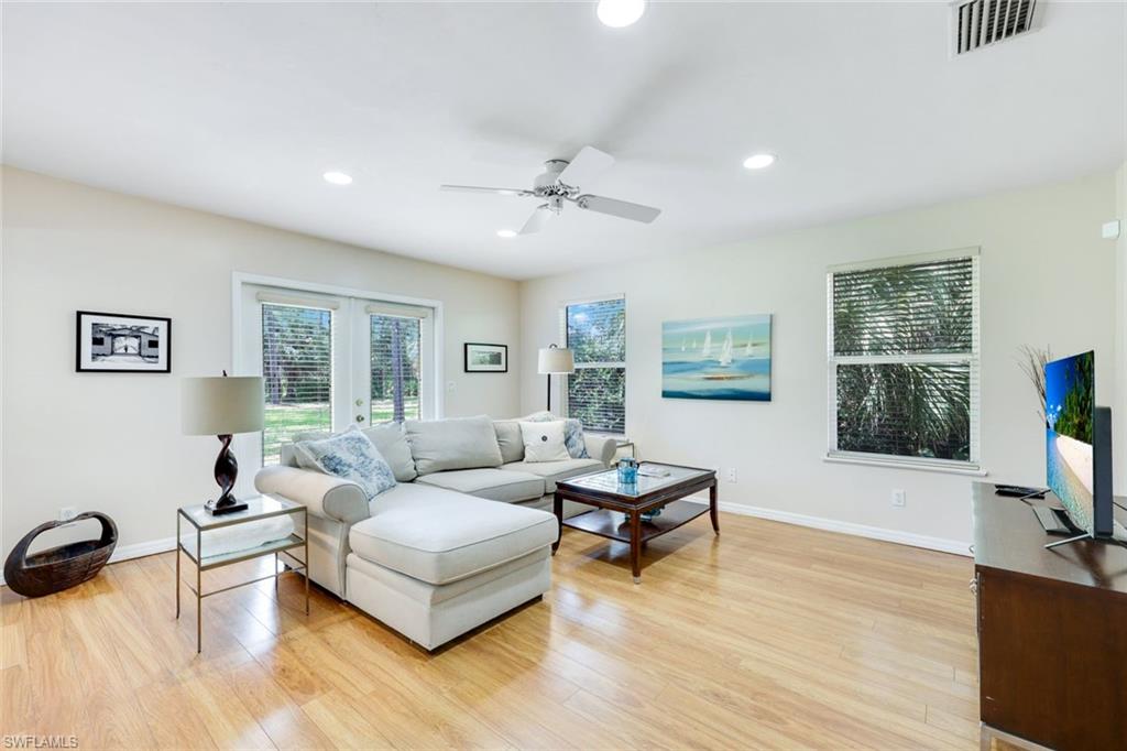 131 Cajeput Drive Naples, FL 34108 - Photo 5 of 30 a living room with furniture and a flat screen tv