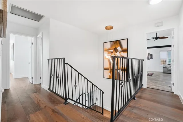 a view of a hallway view with wooden floor and windows