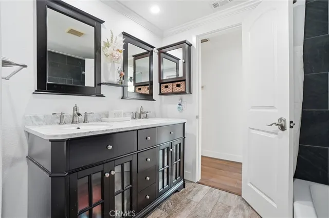 a bathroom with a double vanity sink mirror and