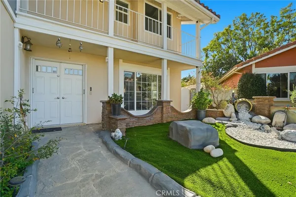 a view of a house with backyard sitting area and garden