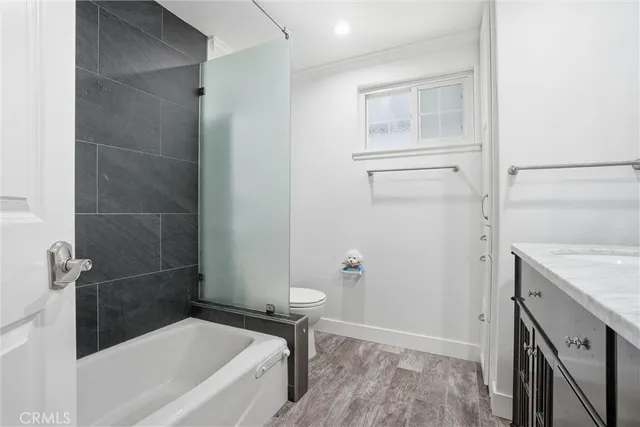 a bathroom with a tub a sink and a stove