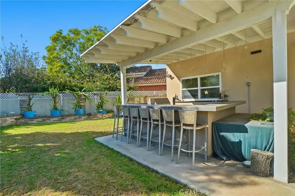 a view of a backyard with a patio and swimming pool
