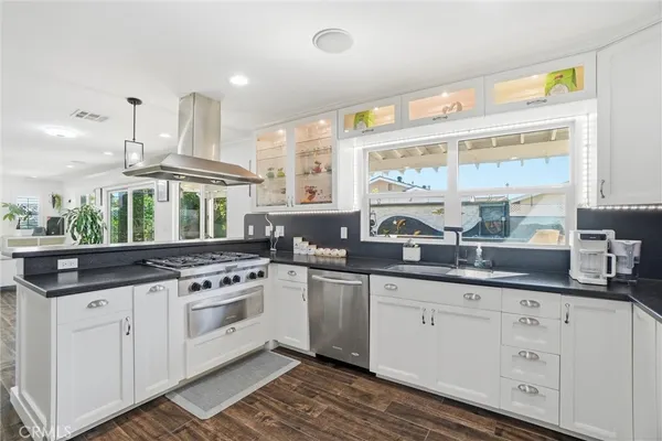 a kitchen with granite countertop white cabinets and white appliances