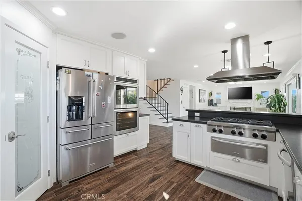 a kitchen with stainless steel appliances and white cabinets