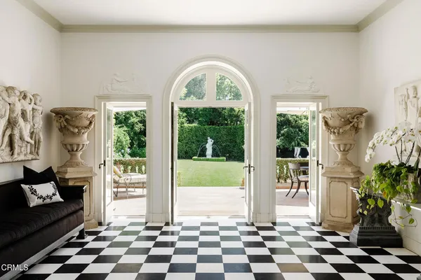 a black and white checkered floor with a black white checkered floor next to a window