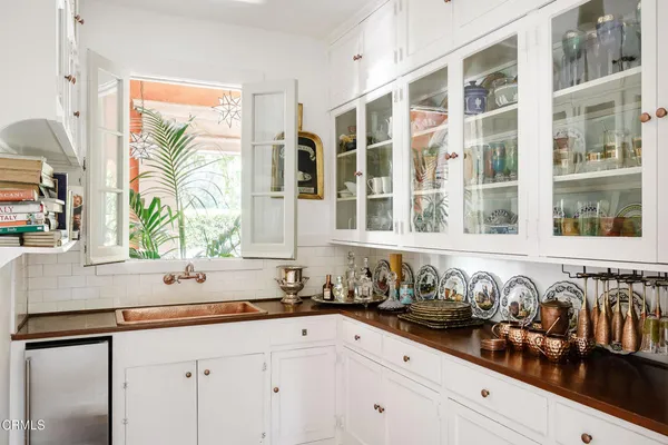 a kitchen with granite countertop a sink a stove and a window