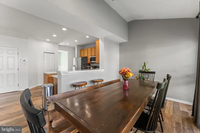 a dining room with furniture and wooden floor