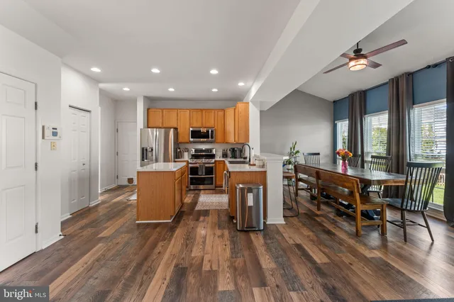 a living room with lots of furniture and kitchen view