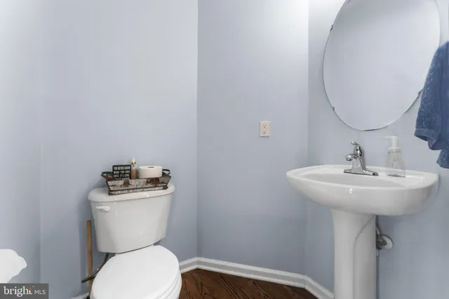 a bathroom with a toilet sink and mirror