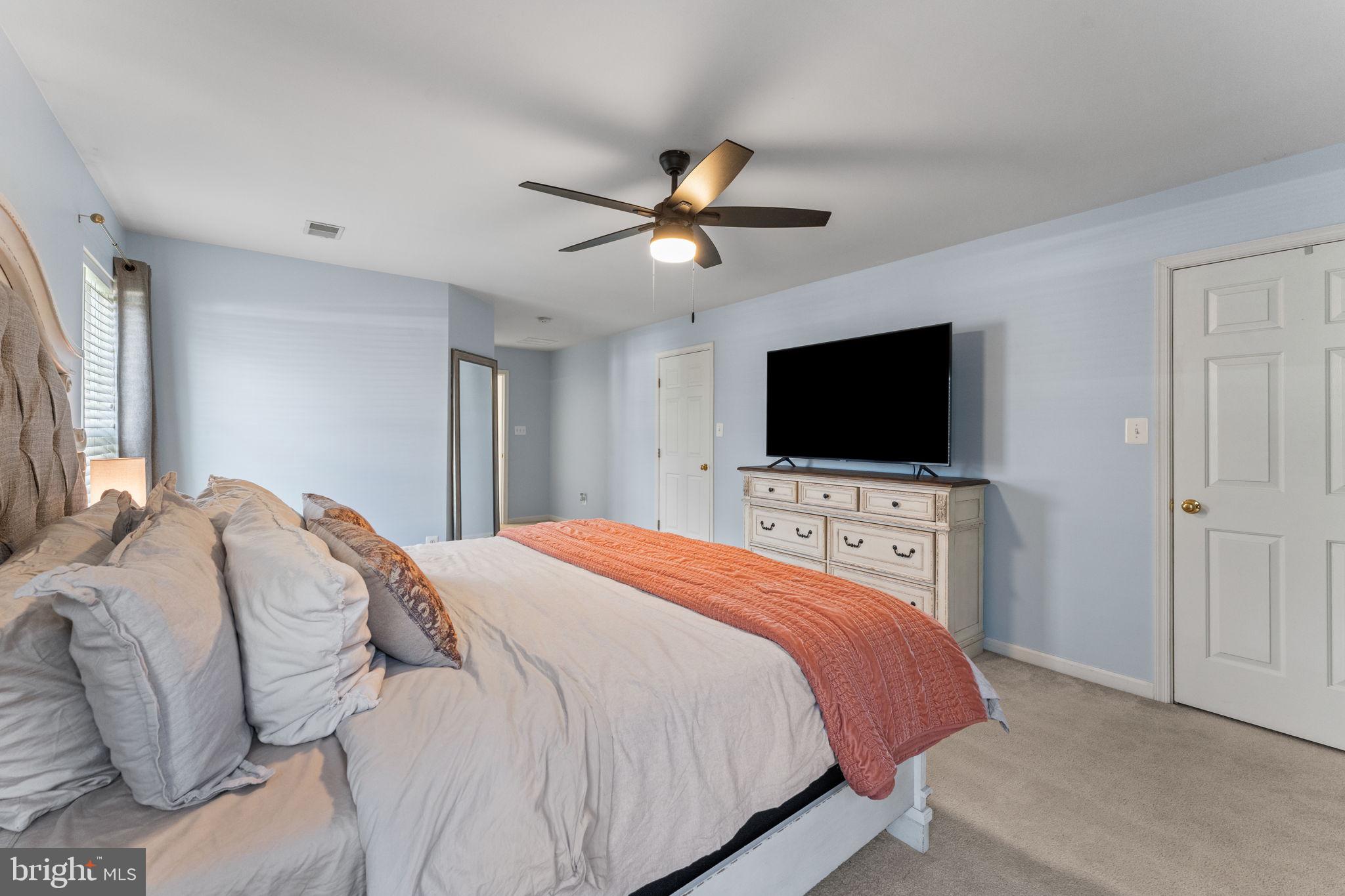 5219 Joshua Tree Circle Fredericksburg, VA 22407 - Photo 19 of 42 a bedroom with a bed tv and a window