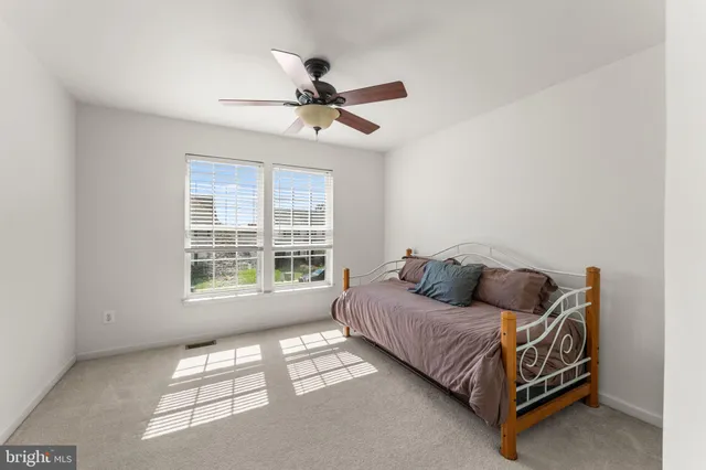 a bedroom with a bed couch and window
