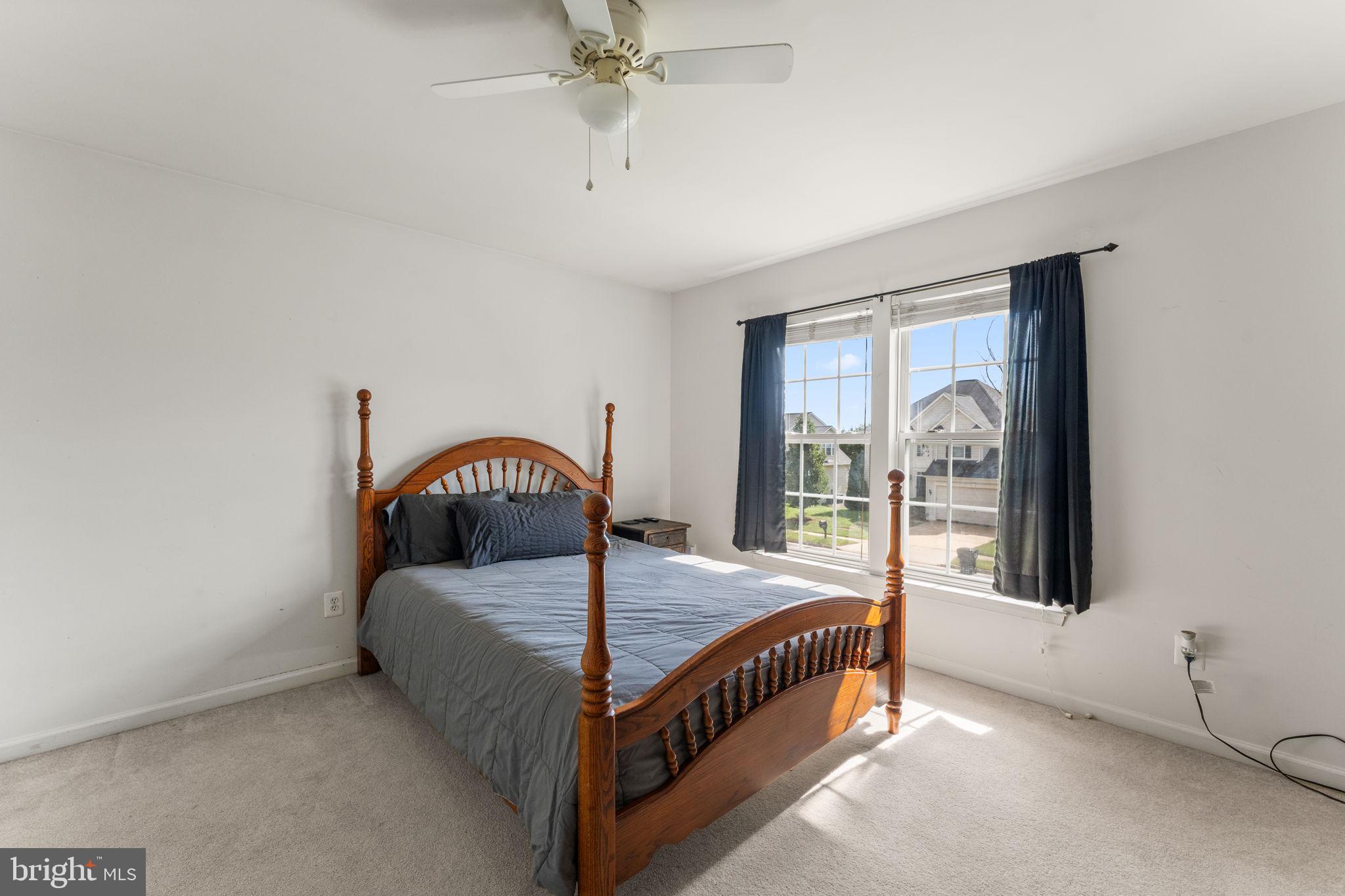 5219 Joshua Tree Circle Fredericksburg, VA 22407 - Photo 29 of 42 a bedroom with a bed and a large window