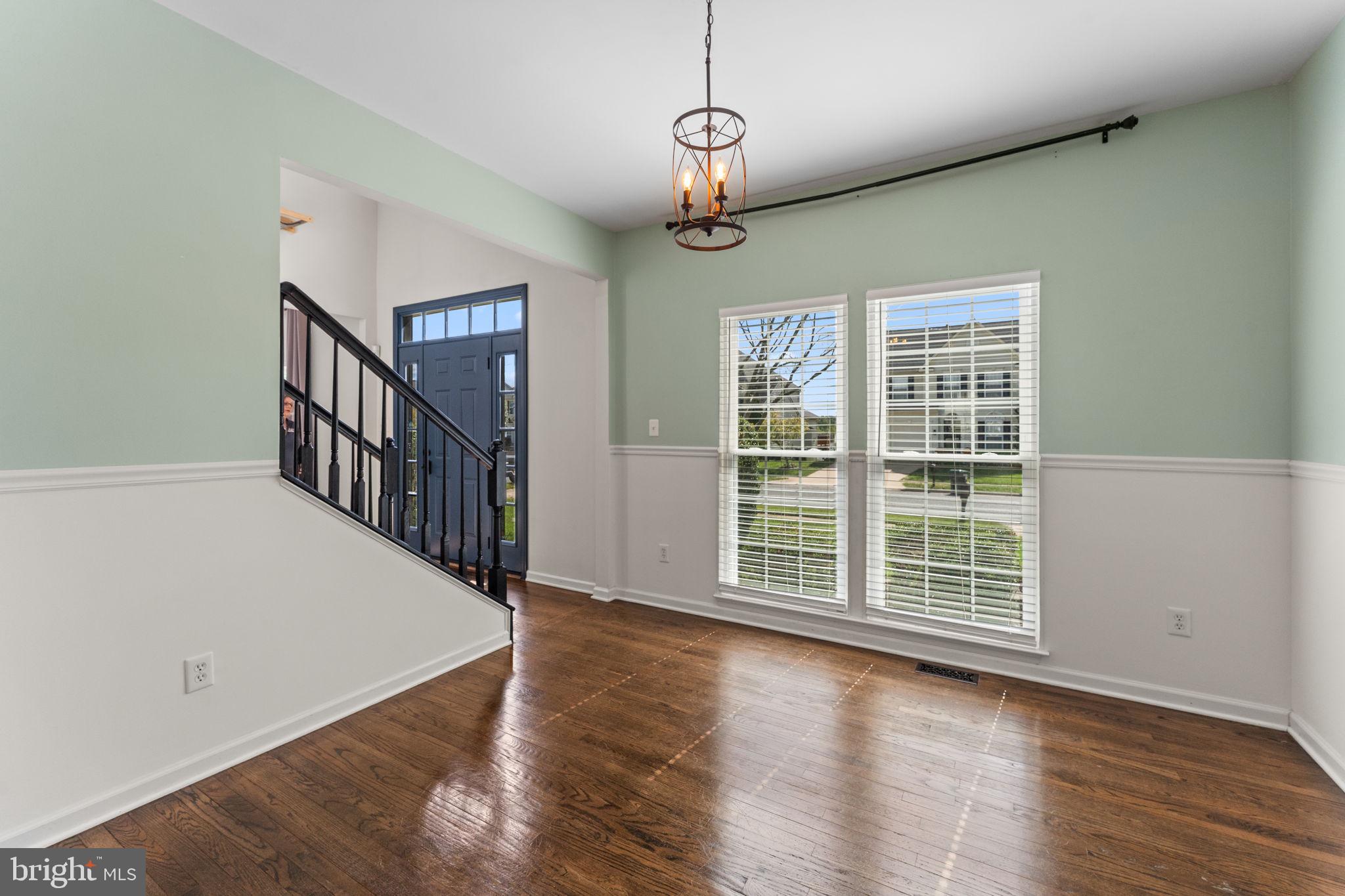 5219 Joshua Tree Circle Fredericksburg, VA 22407 - Photo 3 of 42 a view of an empty room with wooden floor and windows