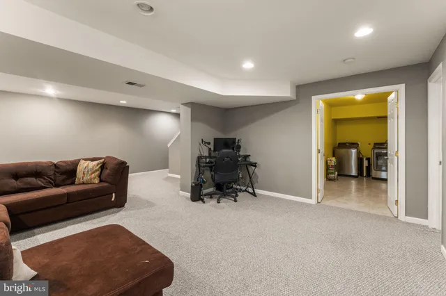 a livingroom with furniture and a gym equipment