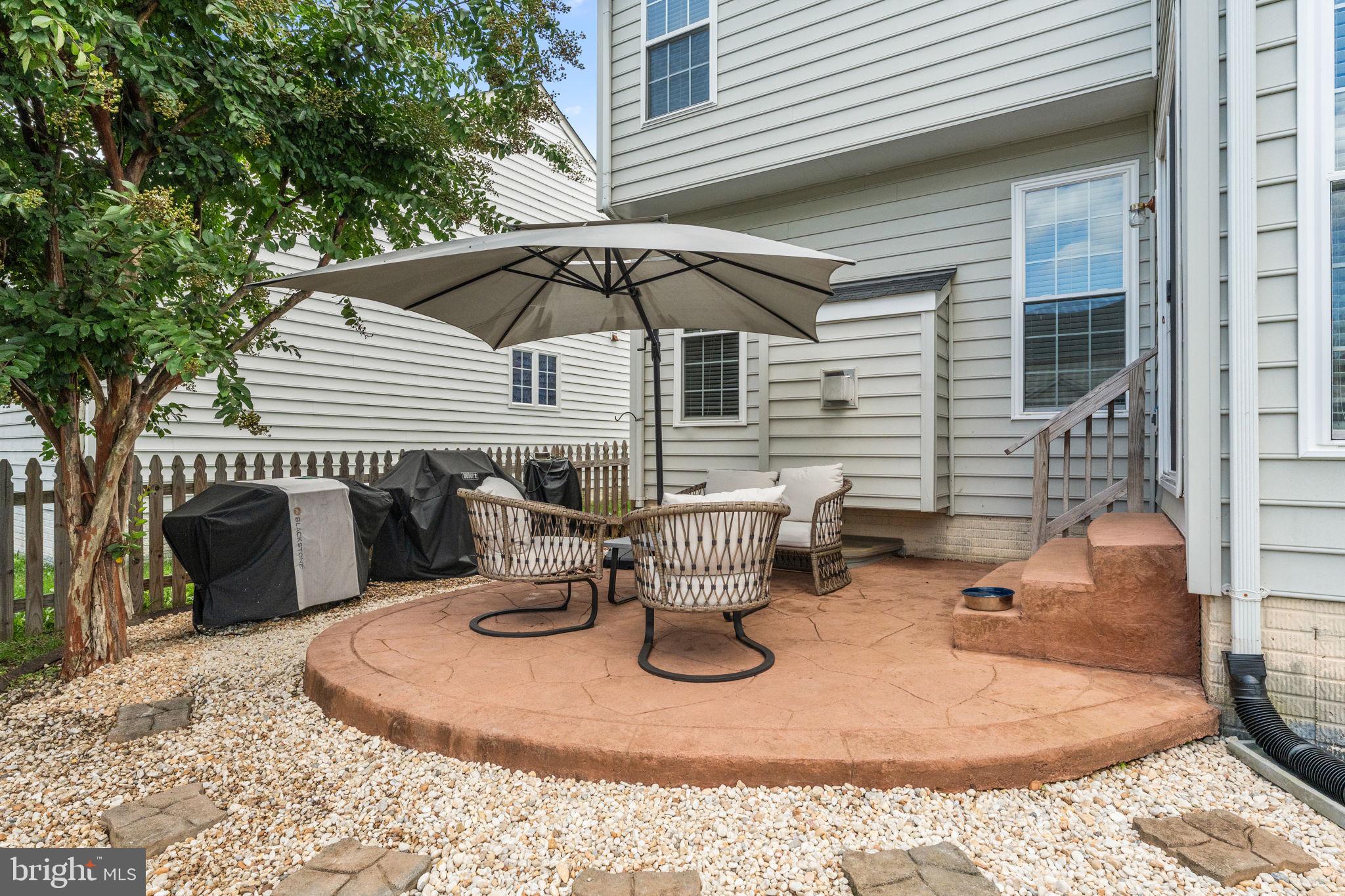 5219 Joshua Tree Circle Fredericksburg, VA 22407 - Photo 42 of 42 a view of a patio with a table and chairs