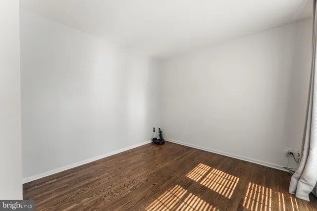 a room with wooden floor and natural light