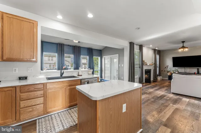 a large kitchen with kitchen island a sink a counter space and stainless steel appliances