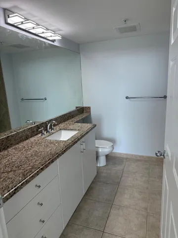 a kitchen with a sink a counter and cabinets