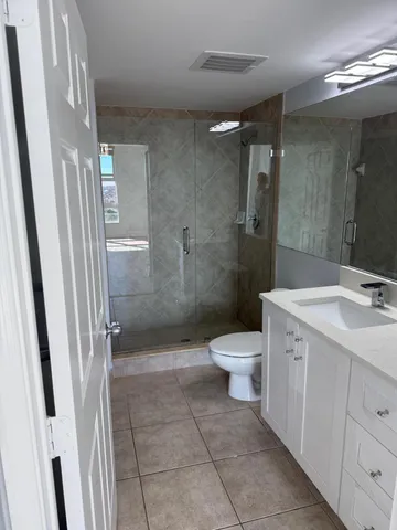 a bathroom with a toilet sink and shower