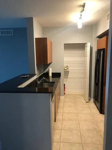 a kitchen with a refrigerator and a sink