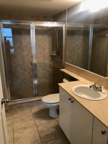 a bathroom with a sink toilet and shower