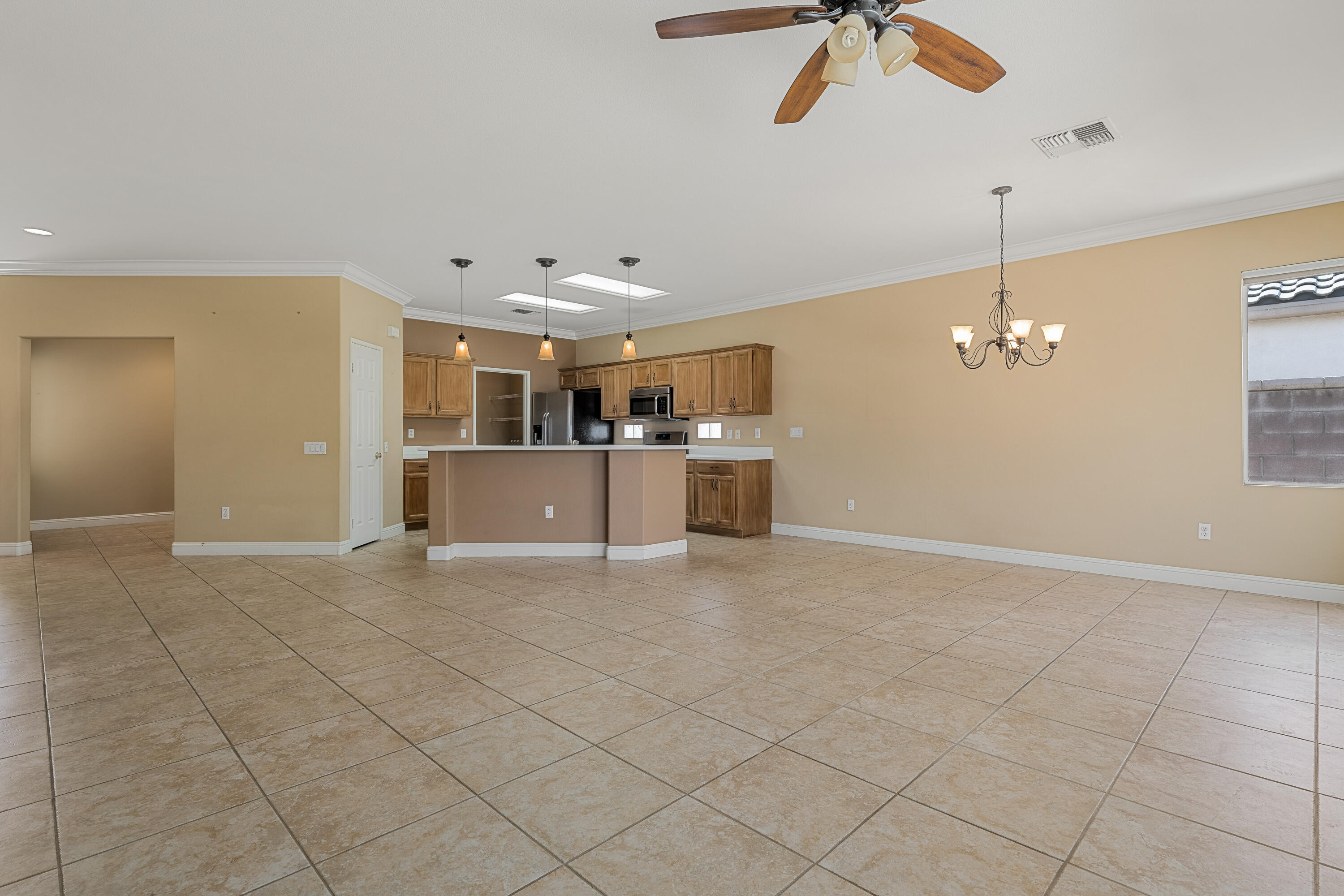 36403 Monarch Pass Palm Desert, CA 92211 - Photo 14 of 32 an empty room with kitchen and ceiling fan