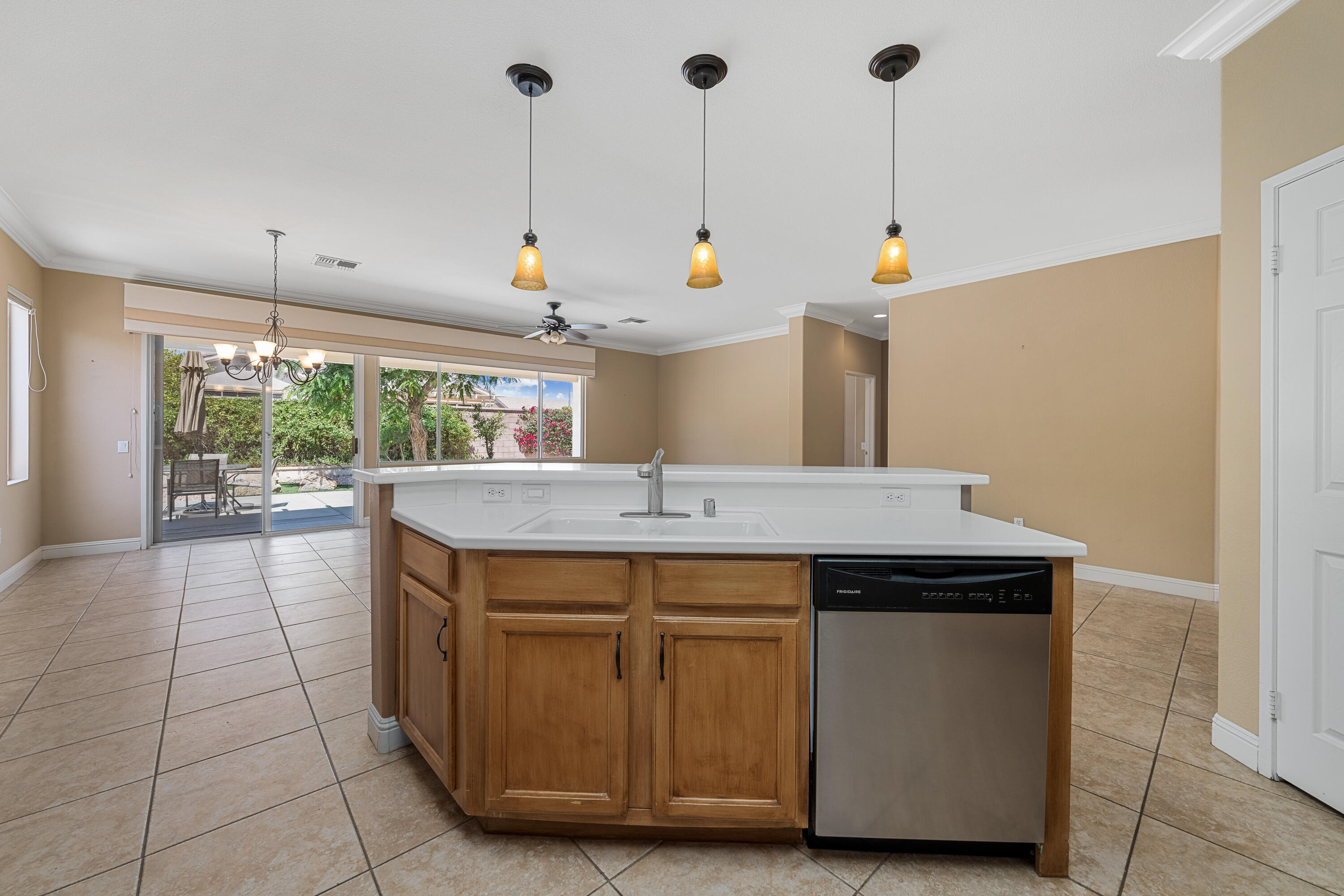 36403 Monarch Pass Palm Desert, CA 92211 - Photo 17 of 32 a kitchen with a stove a sink a window and chairs