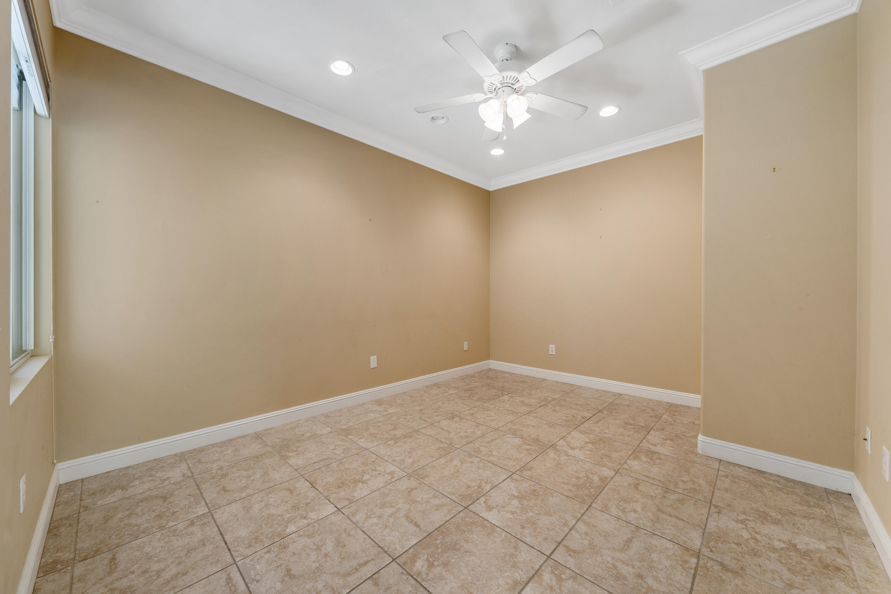 36403 Monarch Pass Palm Desert, CA 92211 - Photo 19 of 32 an empty room with a ceiling fan and a window