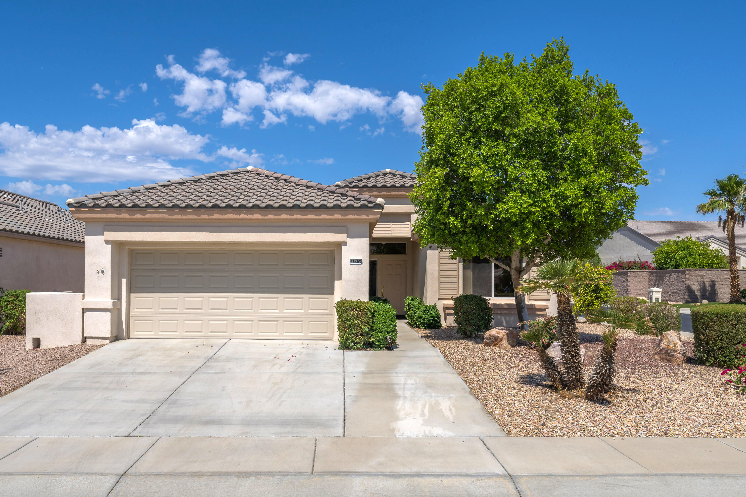 36403 Monarch Pass Palm Desert, CA 92211 - Photo 2 of 32 a front view of a house with garden