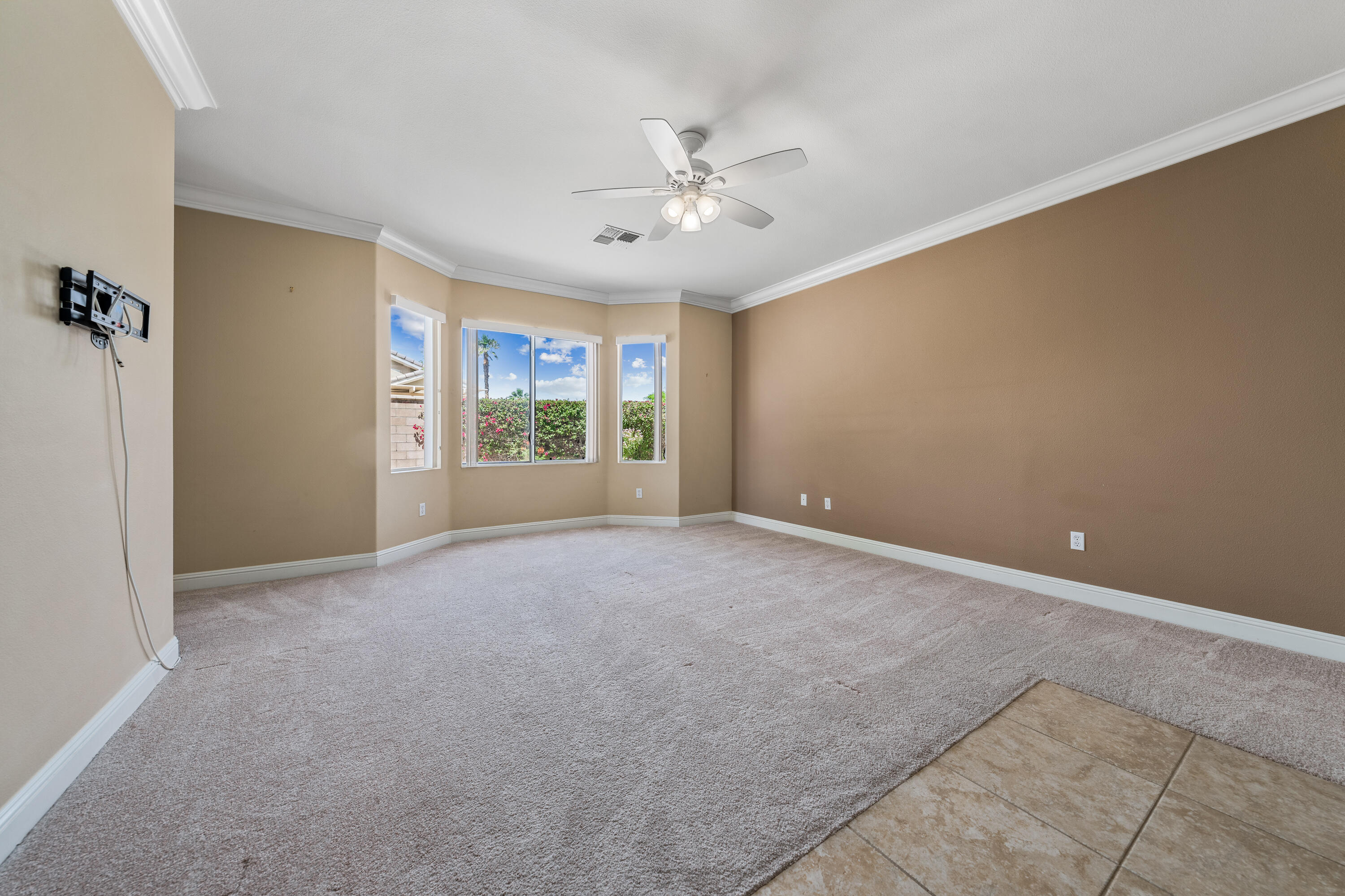 36403 Monarch Pass Palm Desert, CA 92211 - Photo 21 of 32 an empty room with windows and ceiling fan