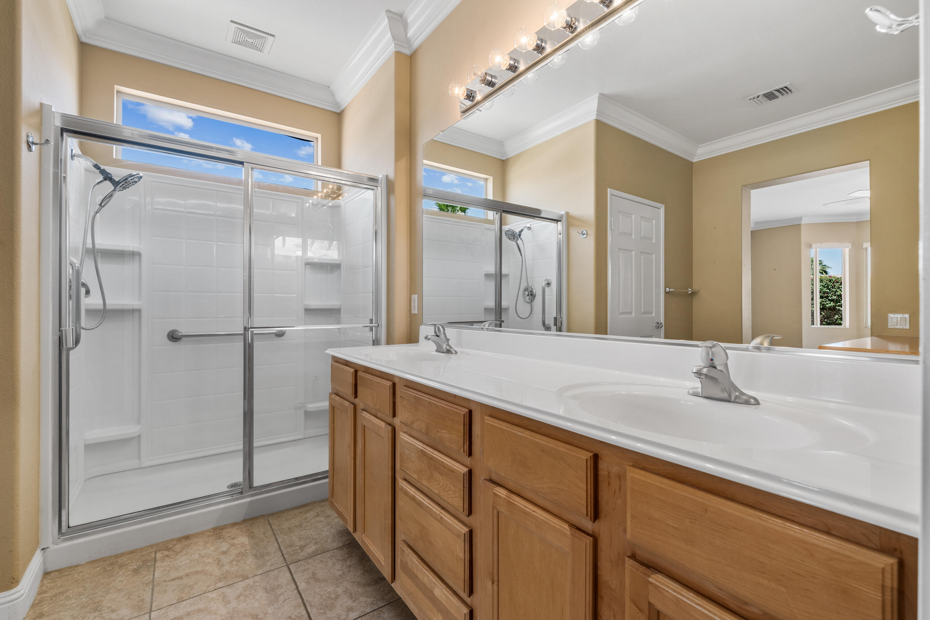 36403 Monarch Pass Palm Desert, CA 92211 - Photo 28 of 32 a bathroom with a shower sink and mirror