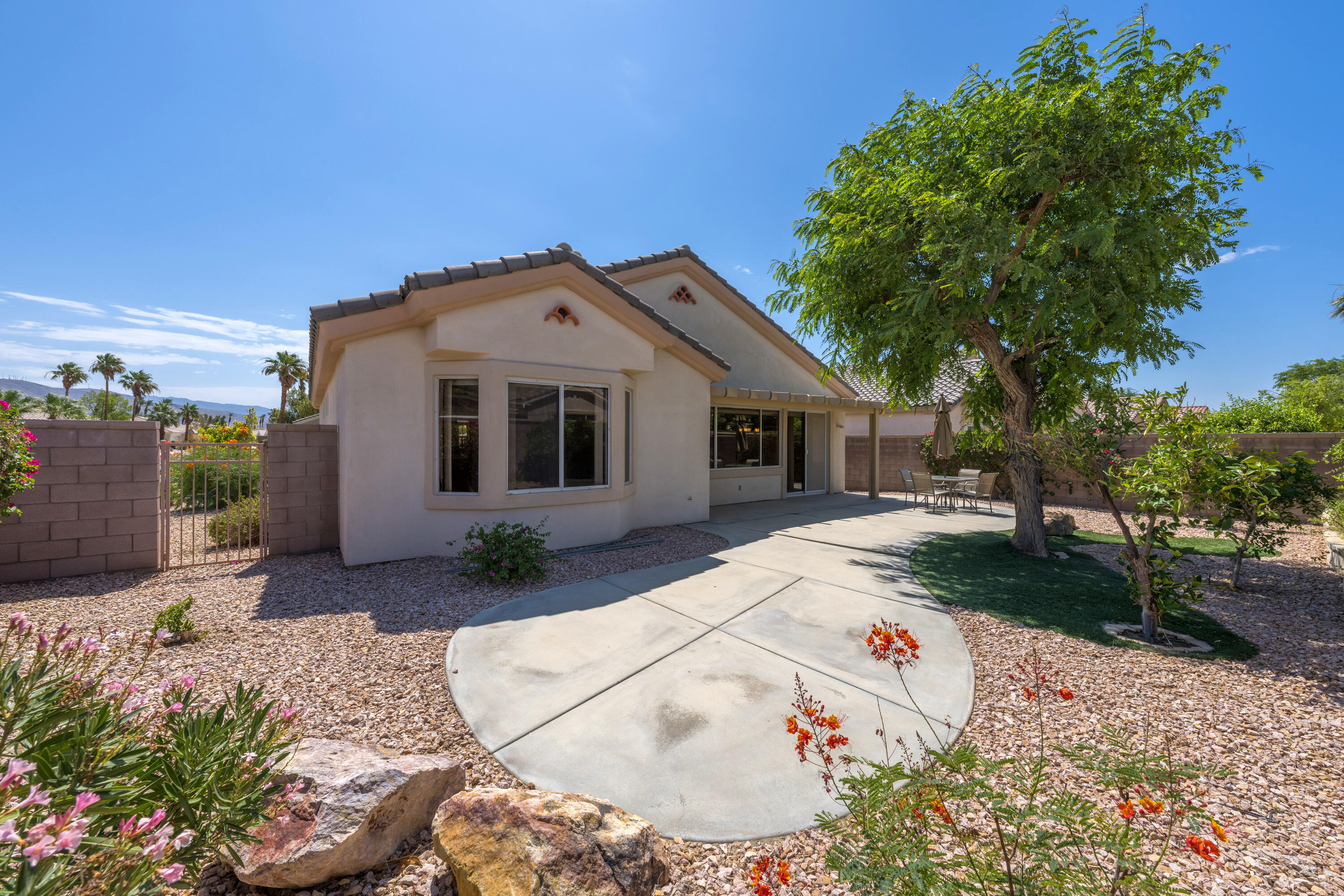 36403 Monarch Pass Palm Desert, CA 92211 - Photo 6 of 32 a front view of a house with a yard