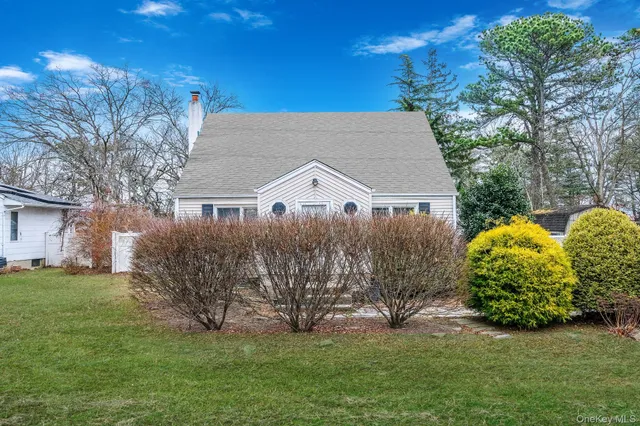 a view of a house with a yard and a garden