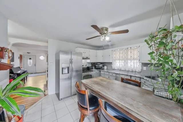 a kitchen with stainless steel appliances granite countertop a sink and a refrigerator