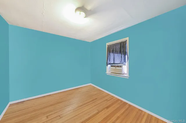 a view of a room with wooden floor and windows