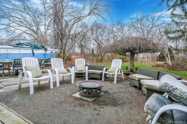 a view of a chairs and table in backyard of the house