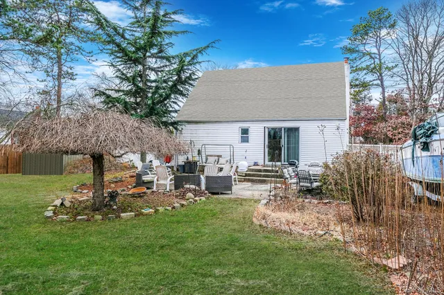 a view of a house with backyard and sitting area