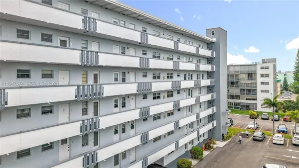 a front view of a building with a garden