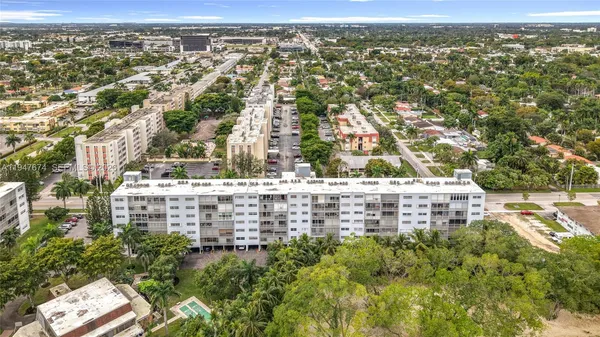 an aerial view of residential houses with outdoor space and river