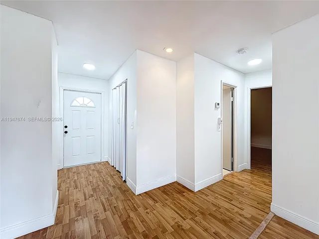 a view of a kitchen with wooden floor