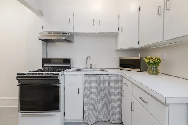 a kitchen with cabinets and appliances