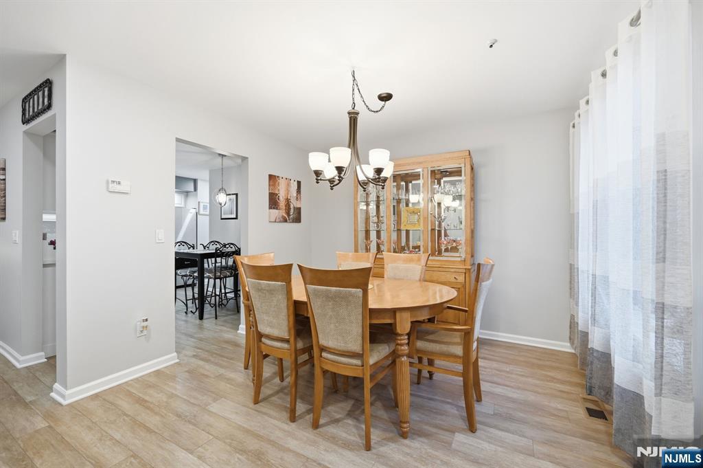 300 Coventry Court Ramsey, NJ 07446 - Photo 11 of 27 a view of a dining room with furniture and wooden floor