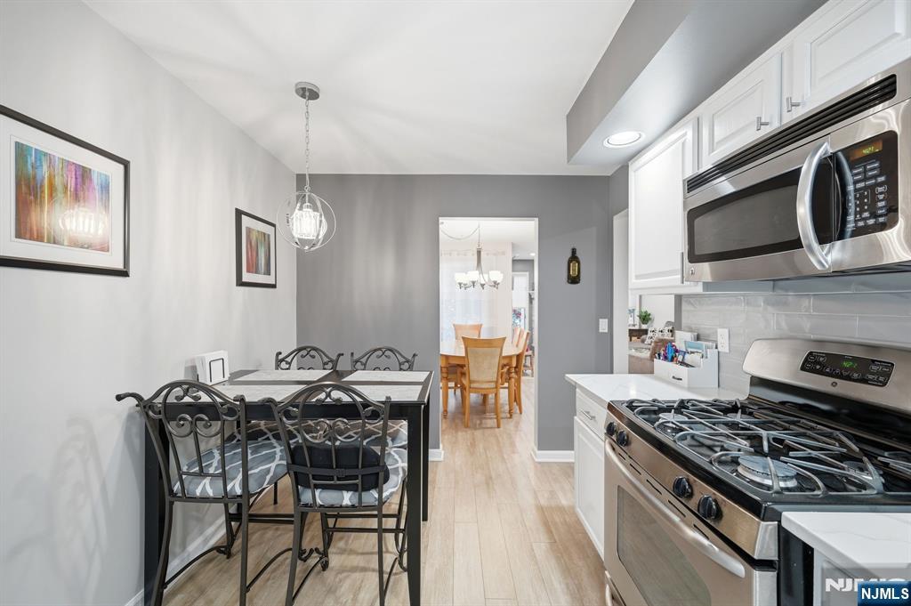 300 Coventry Court Ramsey, NJ 07446 - Photo 15 of 27 a kitchen with stainless steel appliances a stove a table and chairs