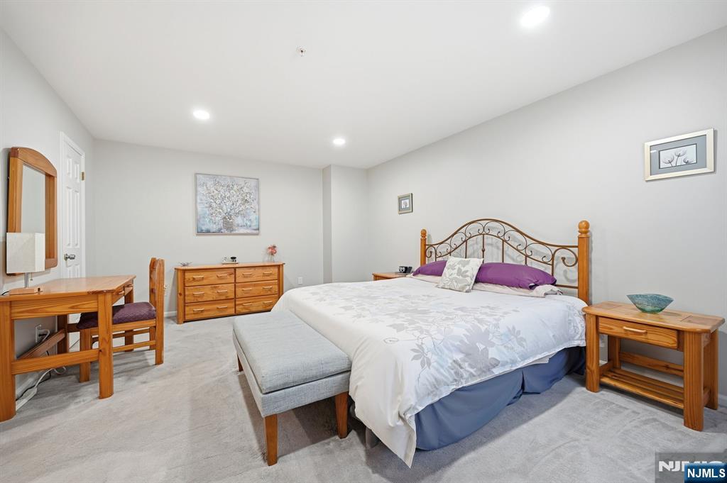 300 Coventry Court Ramsey, NJ 07446 - Photo 19 of 27 a bedroom with a bed a table and chair