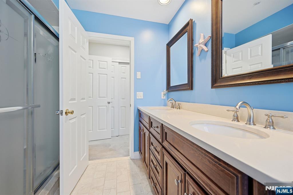 300 Coventry Court Ramsey, NJ 07446 - Photo 23 of 27 a bathroom with a sink a vanity and a mirror
