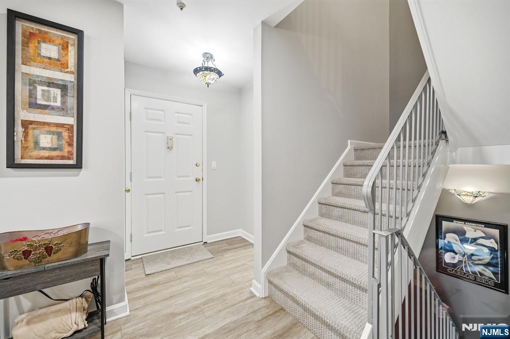 300 Coventry Court Ramsey, NJ 07446 - Photo 5 of 27 a view of a livingroom with wooden floor and stairs