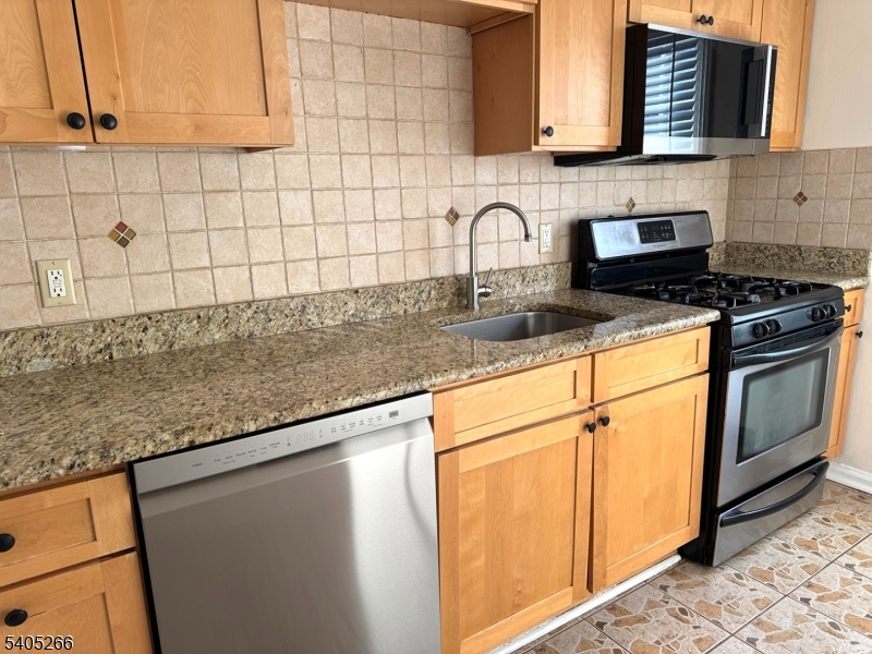 390 Morris Avenue, Unit 35 Summit, NJ 07901 - Photo 1 of 16 a kitchen with granite countertop white cabinets stainless steel appliances and a counter space