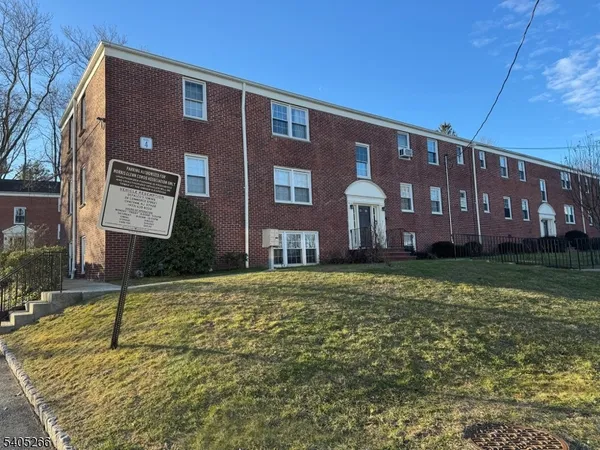 a brick building with a yard in front of it